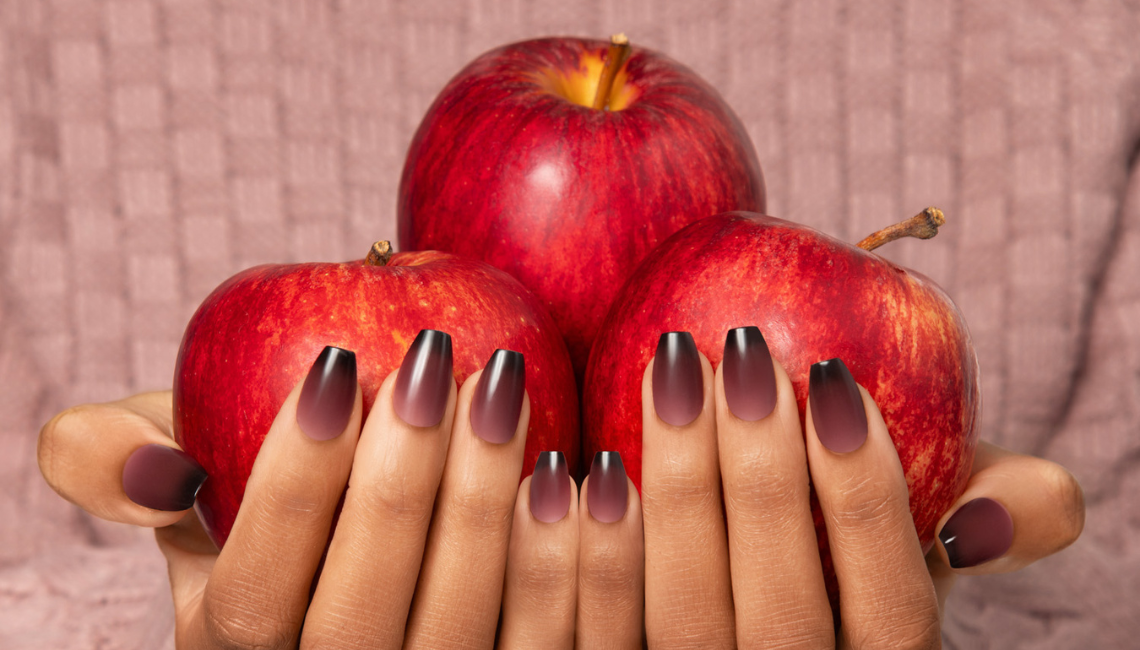 Purple nails holding apples