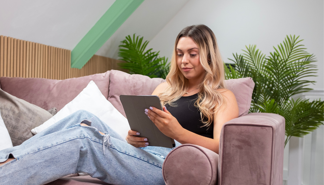 Female on sofa with tablet